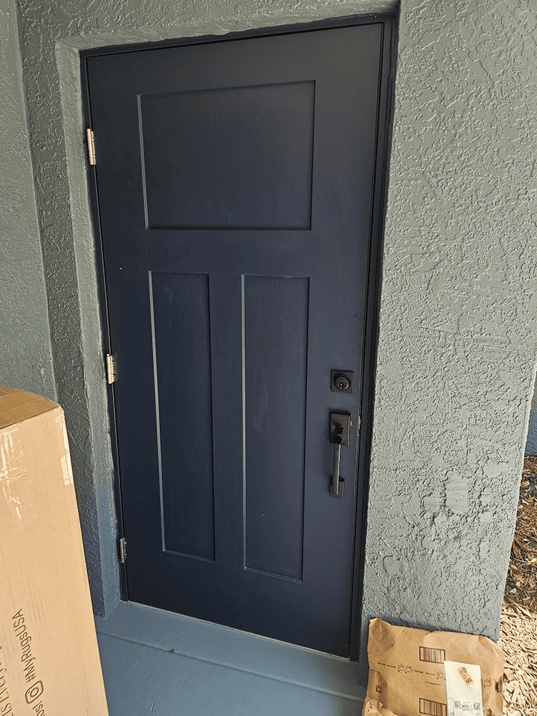 Navy blue front door with delivered packages