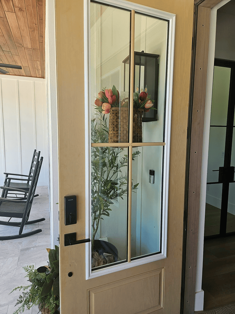 Open front door with tulips in vase Open front door with tulips in vase